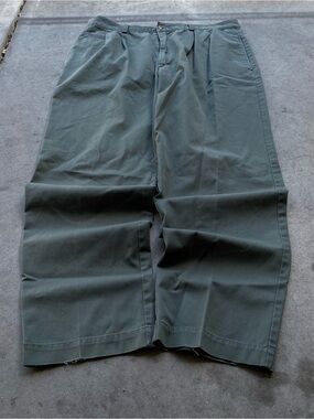 Baggy 90s Bugle Boy green trousers with distressed leg openings